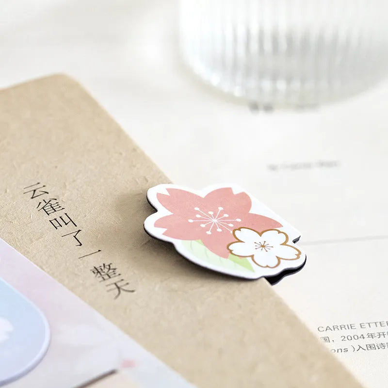 Set of four Yanji magnetic bookmarks with different cherry blossom designs on stone paper.