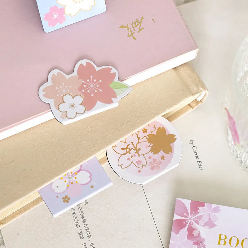 Set of four Yanji magnetic bookmarks with different cherry blossom designs on stone paper.