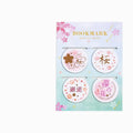 Set of four Yanji magnetic bookmarks with different cherry blossom designs on stone paper.
