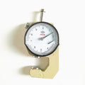 A thickness gauge tool for measuring steel tube, film, and cloth material.