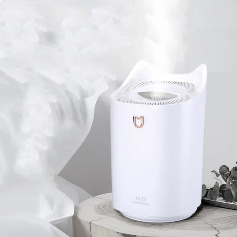 Coral Pink double spray USB humidifier with three mist outlets and a large water tank on a wooden surface.