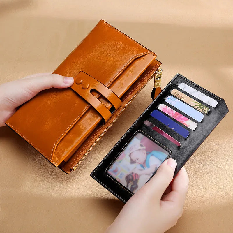 Women's oil wax leather wallet handbag with buckle closure showing internal card slots and compartments