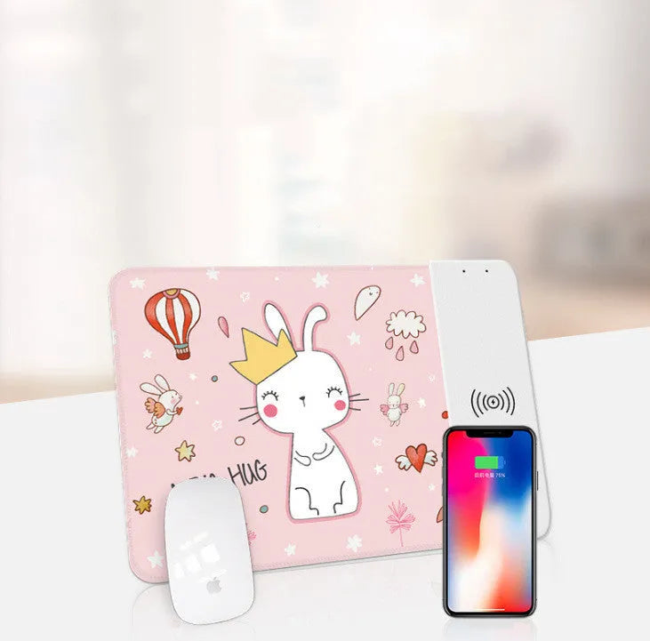 Black cartoon wireless charging mouse pad with glowing RGB lights on a desk.