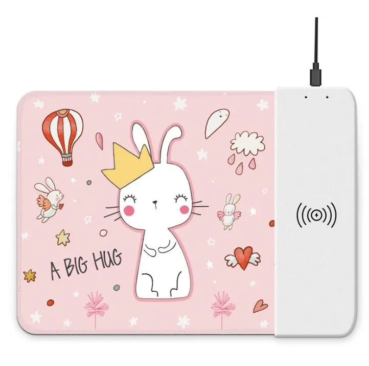 Black cartoon wireless charging mouse pad with glowing RGB lights on a desk.