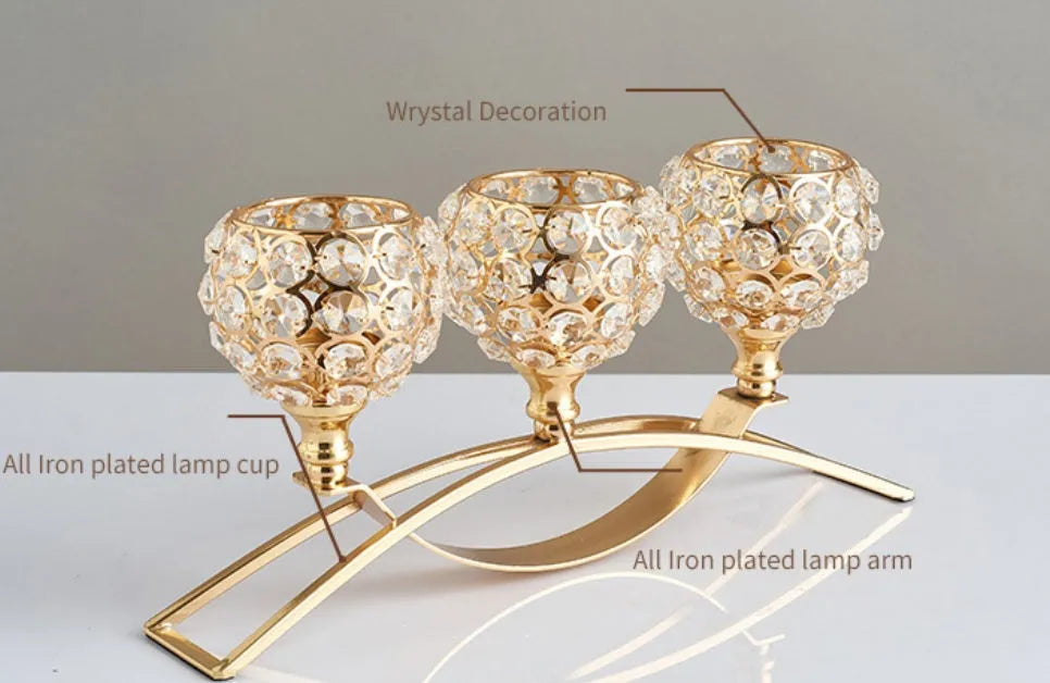 Gold crystal candle holder with geometric wrought iron frame on a table surface