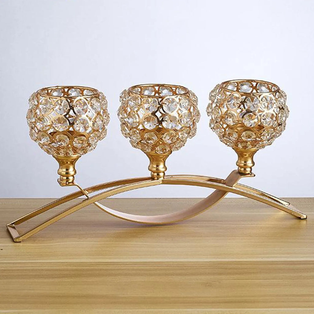 Gold crystal candle holder with geometric wrought iron frame on a table surface