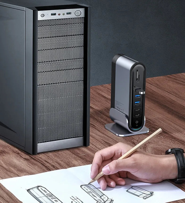 Deep space grey 16-in-1 USB-C docking station and power supply on a desk.