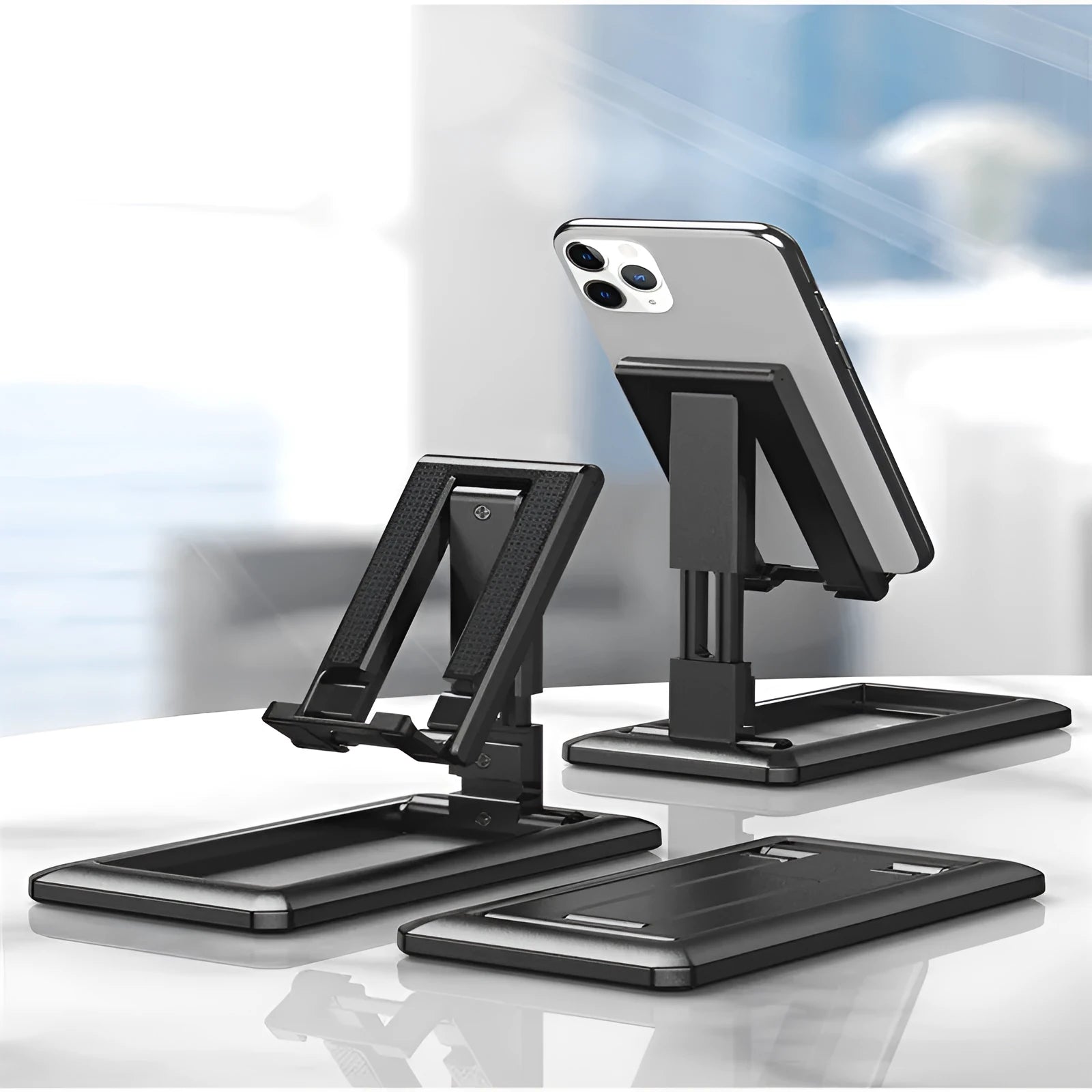 Retractable lazy folding mobile phone stand in an adjustable position, shown in multiple colours.