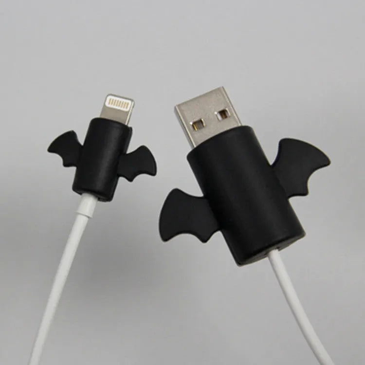 White and black silicone cable protective covers shown next to a charging cable.