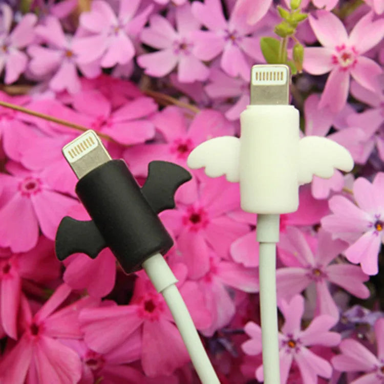 White and black silicone cable protective covers shown next to a charging cable.