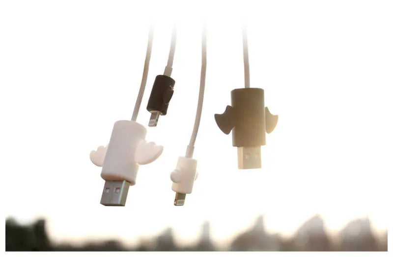 White and black silicone cable protective covers shown next to a charging cable.