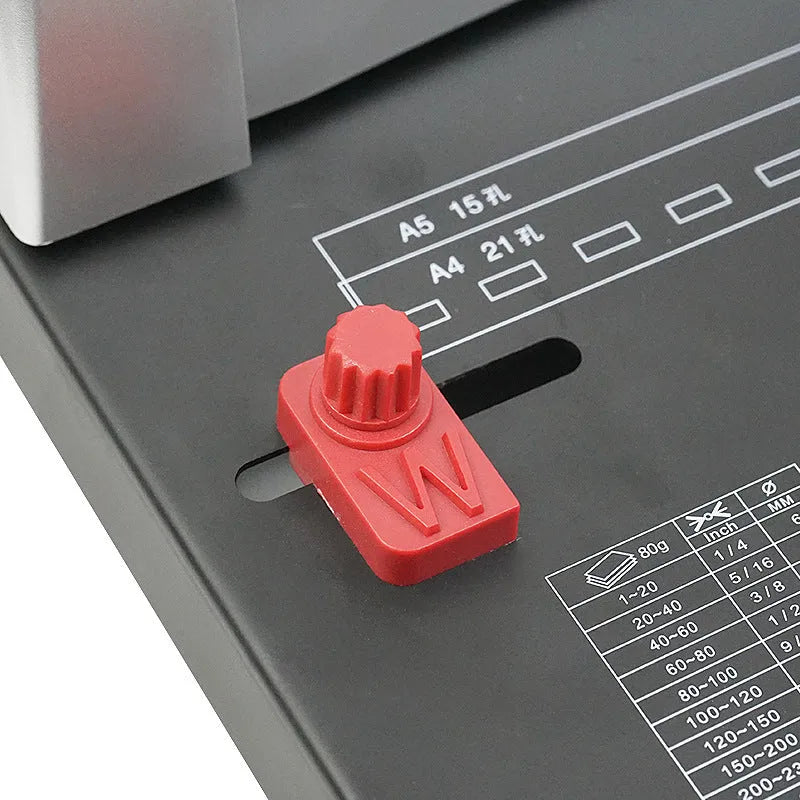 White manual A4 21-hole clamp strip binding machine on desk