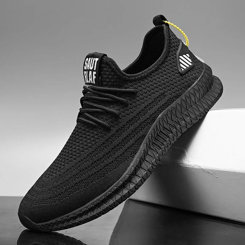 Men's mesh running shoes in black with flying weave upper and white EVA sole on grey background