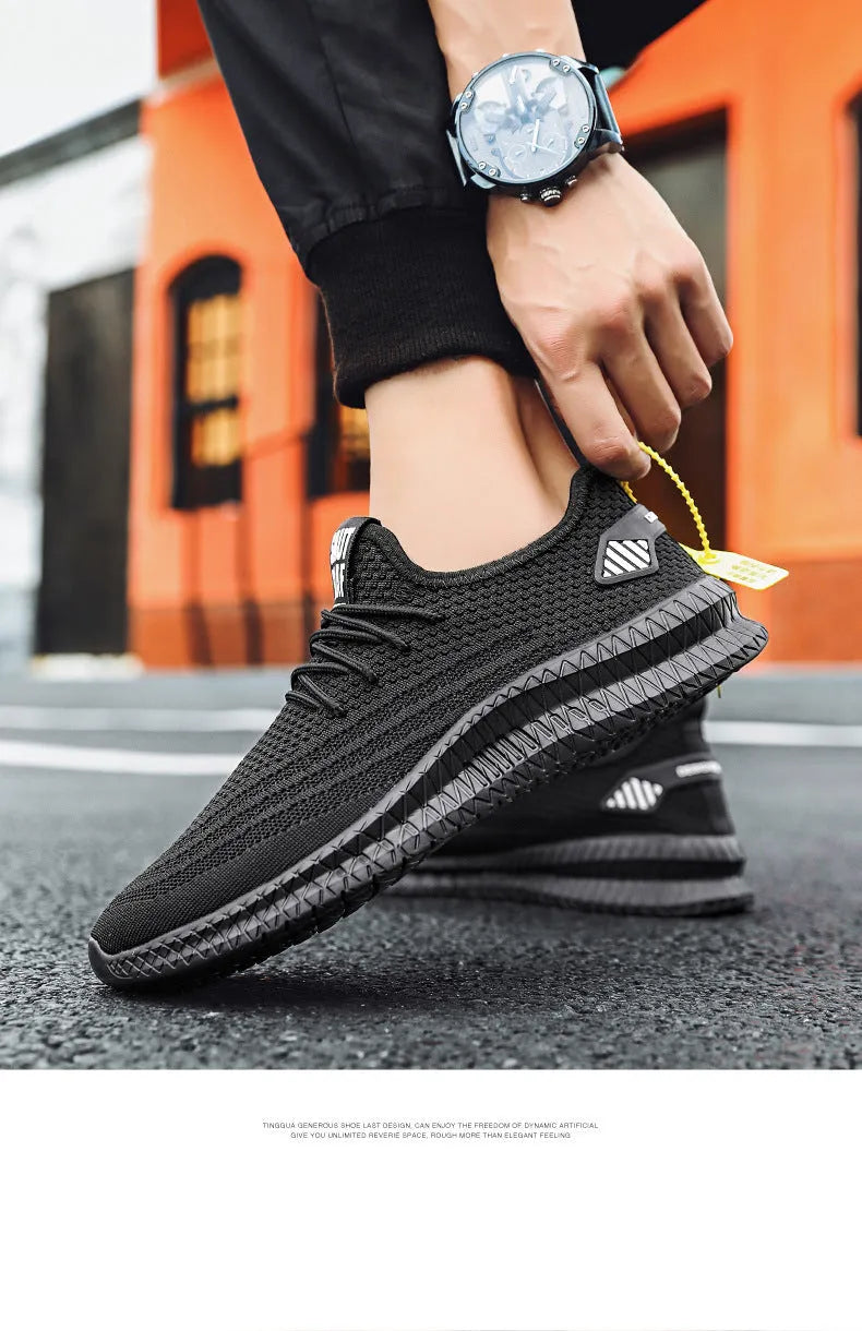 Men's mesh running shoes in black with flying weave upper and white EVA sole on grey background