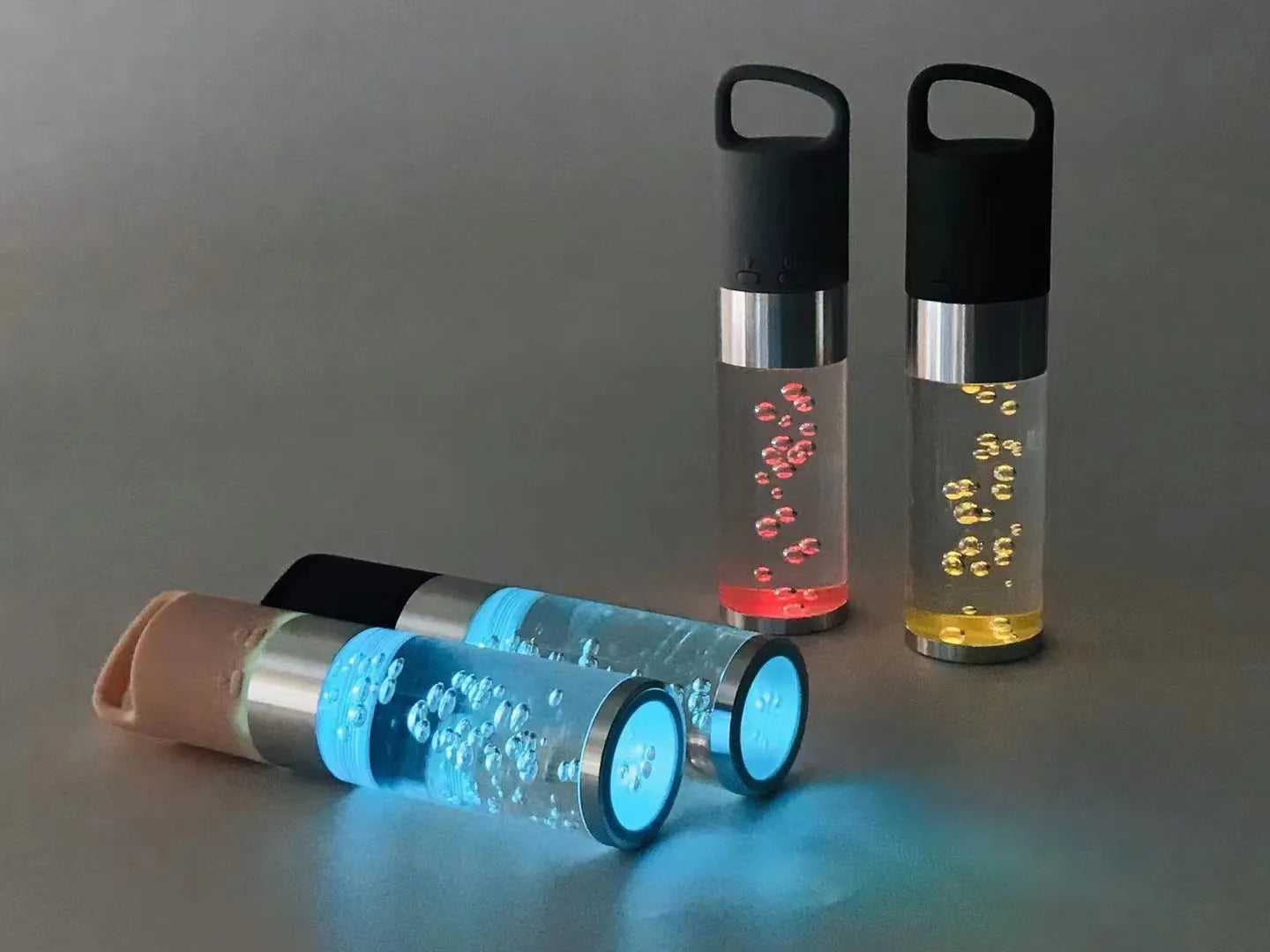Pink portable Bluetooth speaker with illuminated crystal light panel on front, showing compact size.