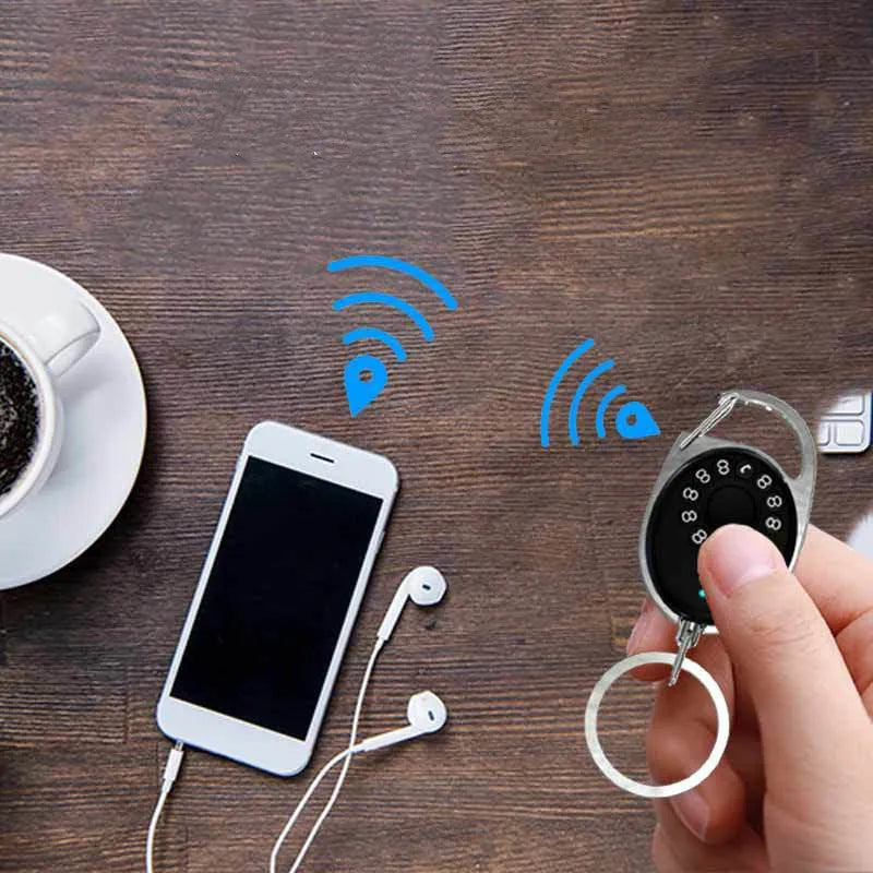 Black Bluetooth anti-lost tracker and selfie remote keychain compatible with Apple iPhone.