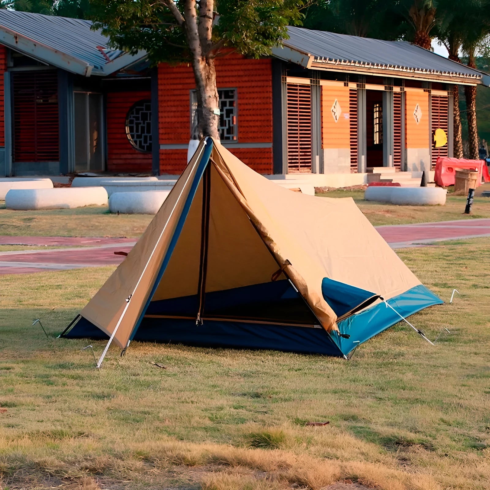 Yellow single outdoor tent with carbon fibre frame set up on grass, unfolded size 211x122x91 cm
