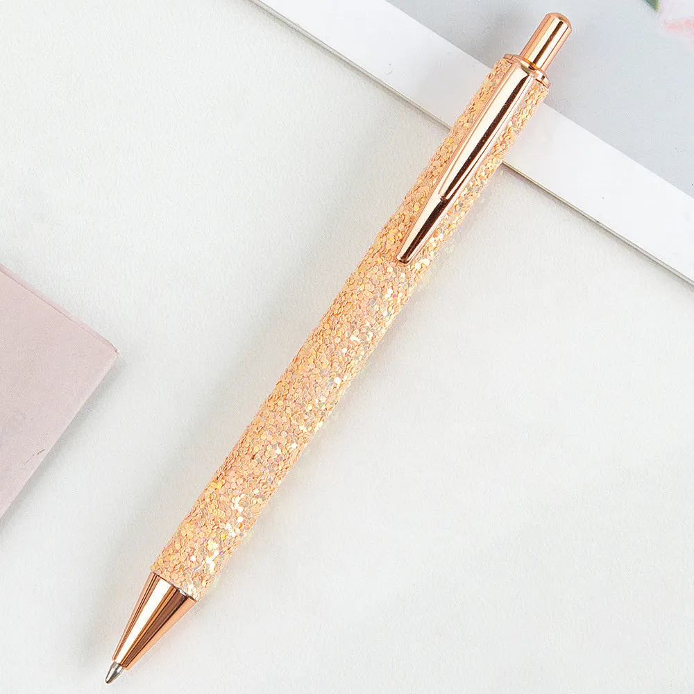 Metal push ballpoint pen with sequin design in multiple colours on white background