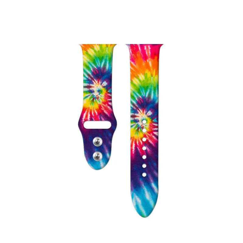 Colourful tie-dye patterned silicone replacement band for Apple Watch on a wrist.