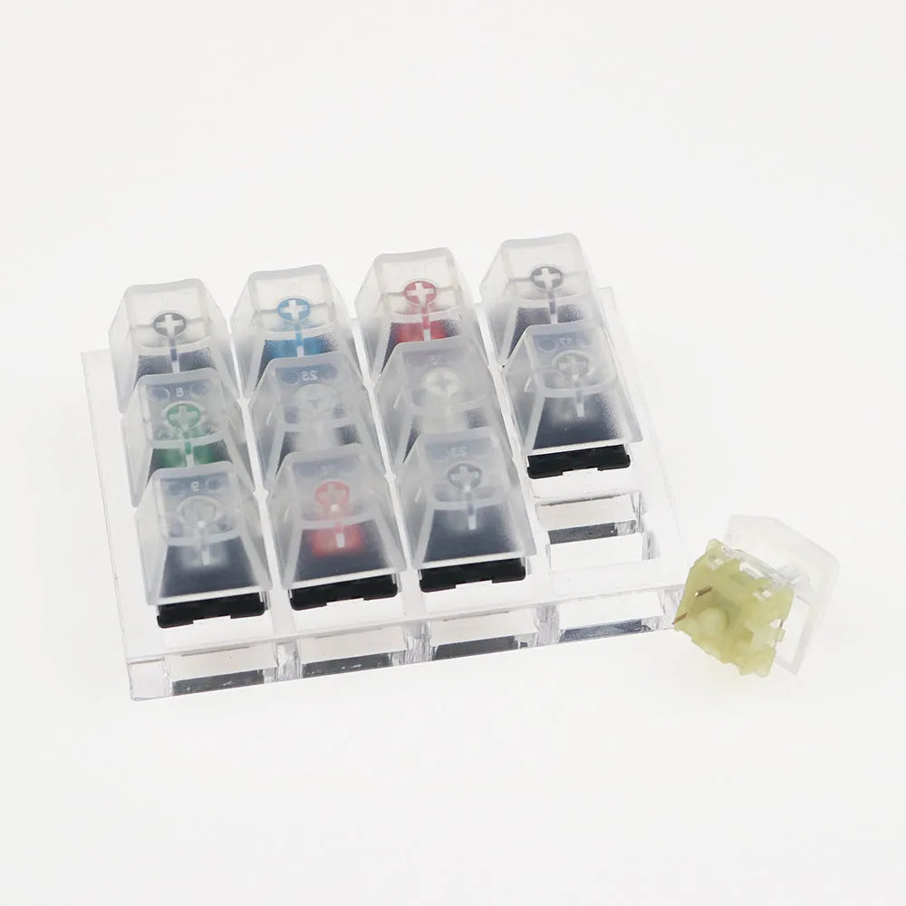 White mechanical keyboard switch tester with twelve different Cherry MX keys including black and green switches