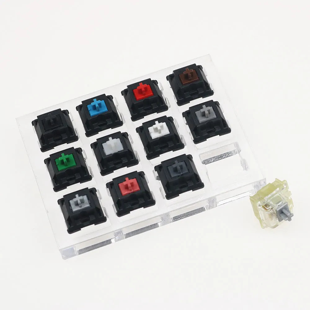 White mechanical keyboard switch tester with twelve different Cherry MX keys including black and green switches