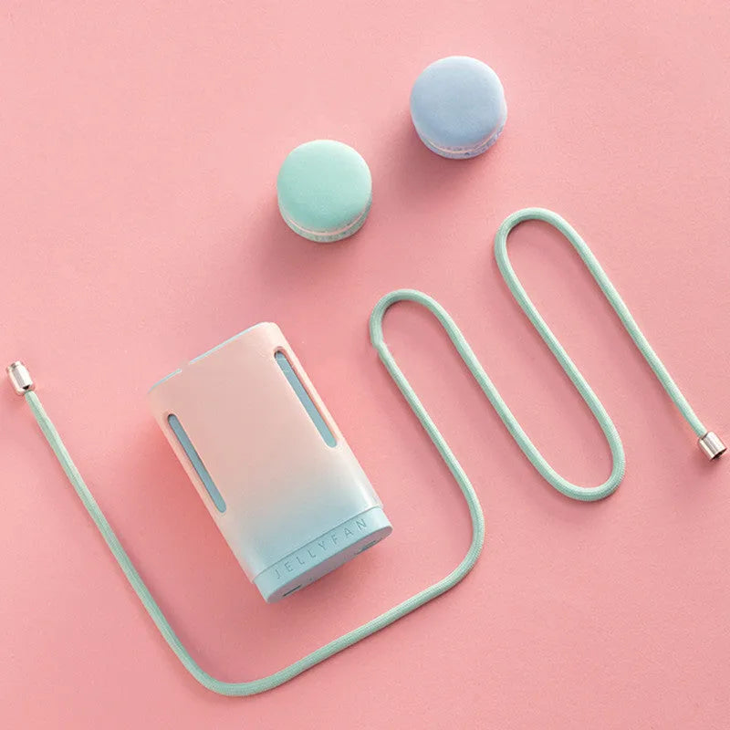 Jelly USB hanging neck and handheld mini fan in mint peach colour showing compact size.