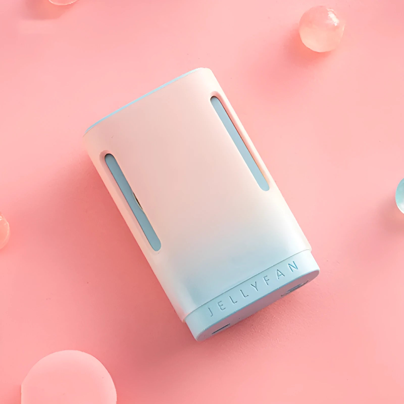 Jelly USB hanging neck and handheld mini fan in mint peach colour showing compact size.
