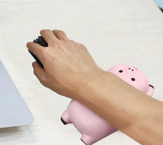 Black PU wristband mouse pad on a desk, showing its non-slip surface and compact 130mm by 70mm size.