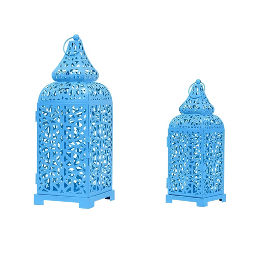 A blue hollow iron candelabra with geometric cut-outs in a Moroccan lantern style, holding a candle.