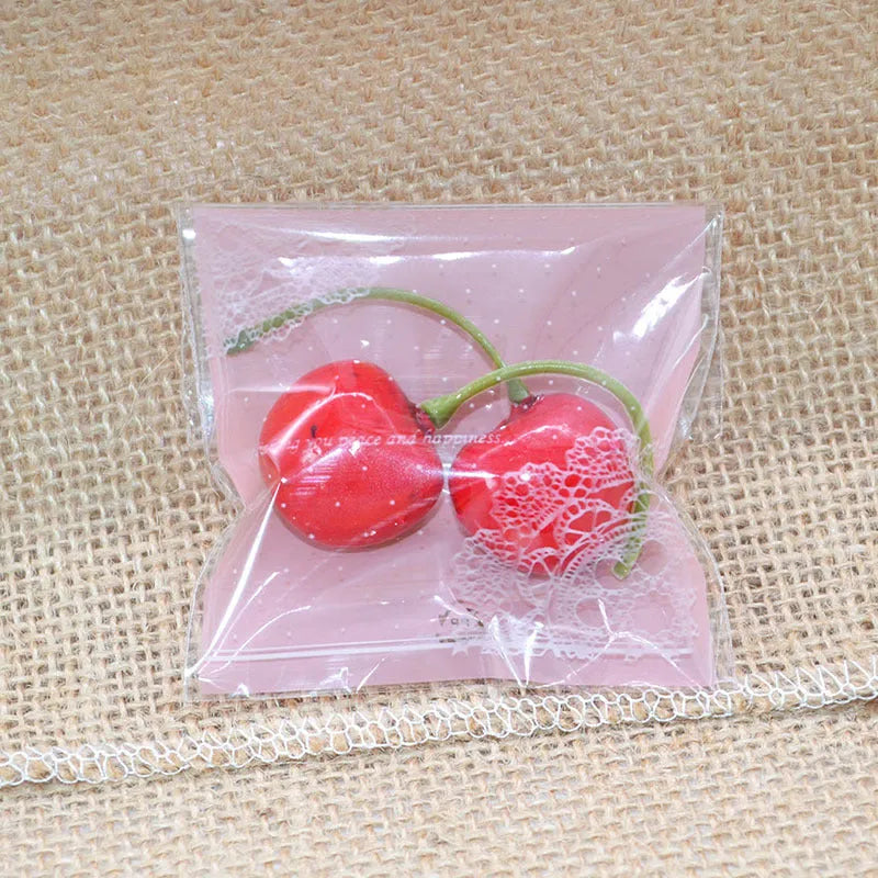 Clear self-adhesive plastic bag for handmade soap with pink UV printing and a 3cm side gusset.
