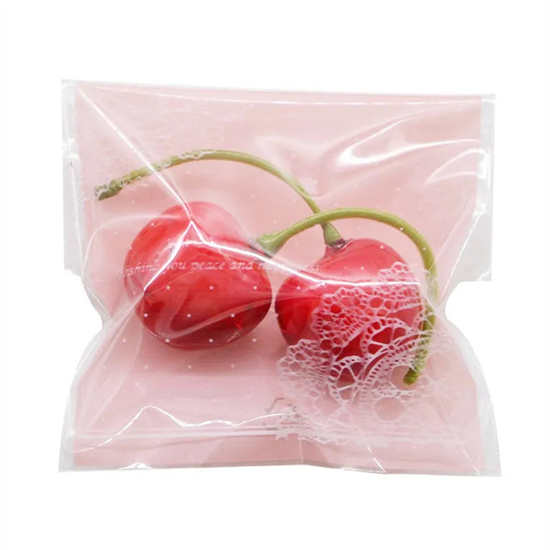 Clear self-adhesive plastic bag for handmade soap with pink UV printing and a 3cm side gusset.