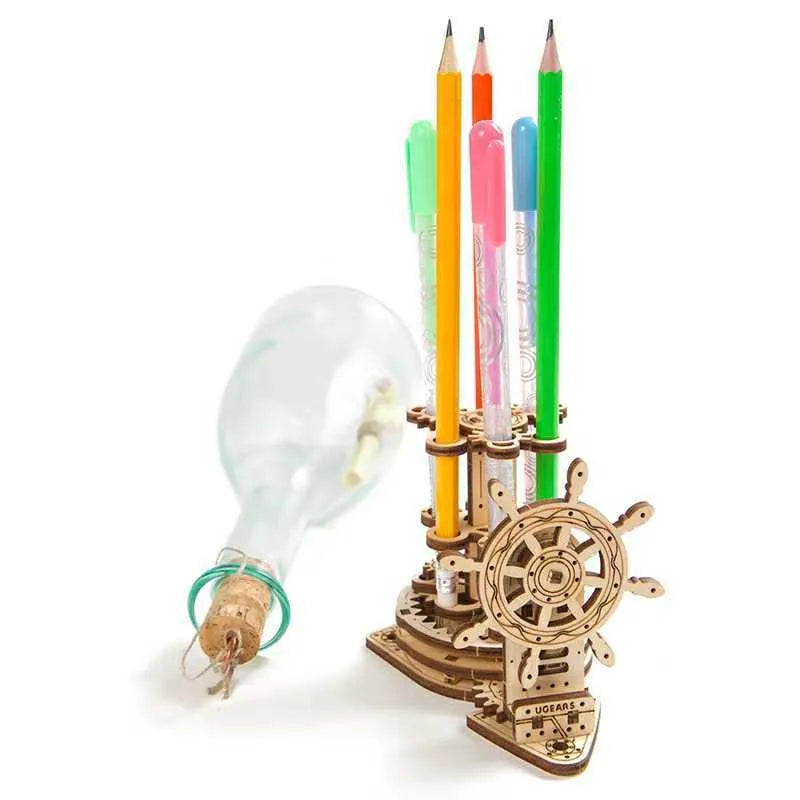 Ukrainian wooden desk pen holder with a rotating steering wheel mechanism, holding coloured pencils.