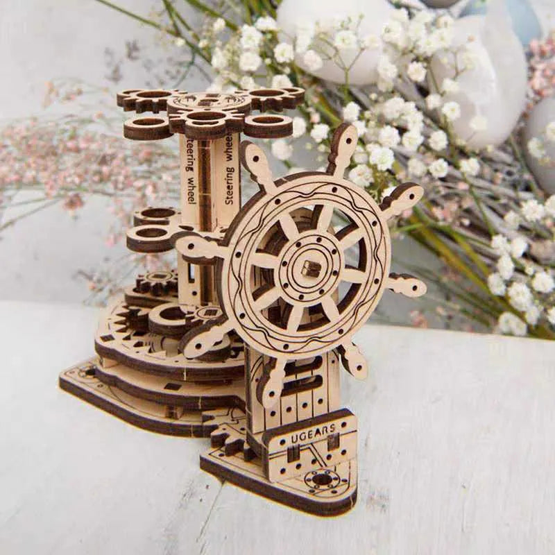 Ukrainian wooden desk pen holder with a rotating steering wheel mechanism, holding coloured pencils.