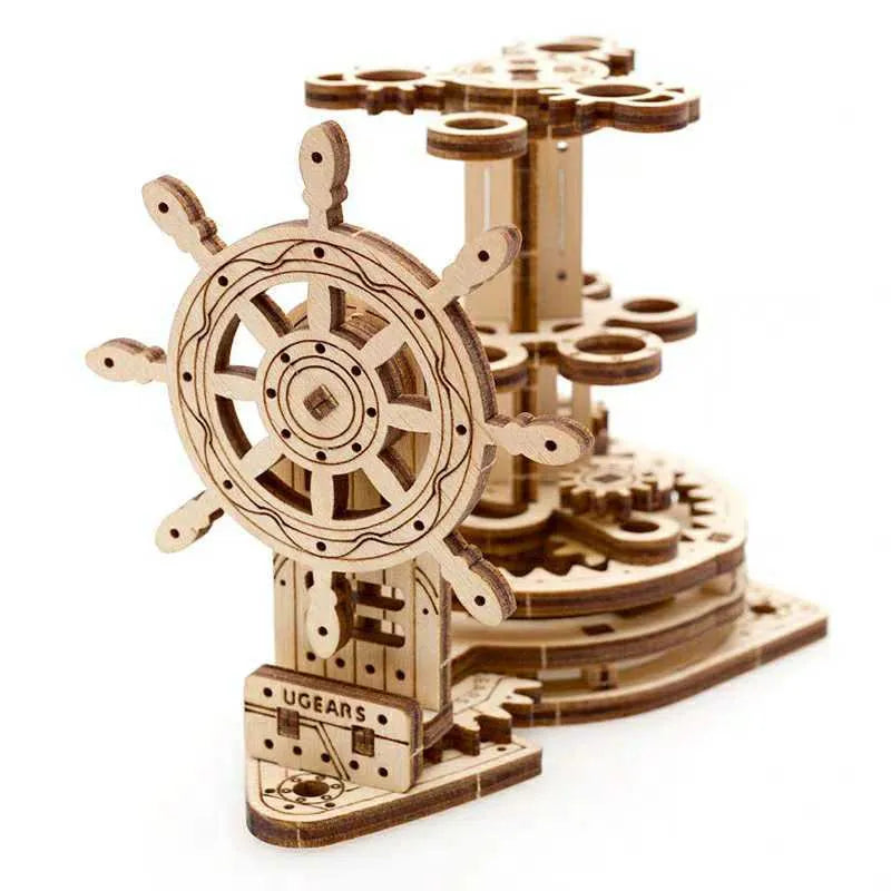 Ukrainian wooden desk pen holder with a rotating steering wheel mechanism, holding coloured pencils.