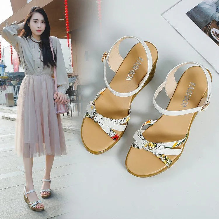Women's pink wedge heel sandals with a single adjustable buckle strap on a white background.