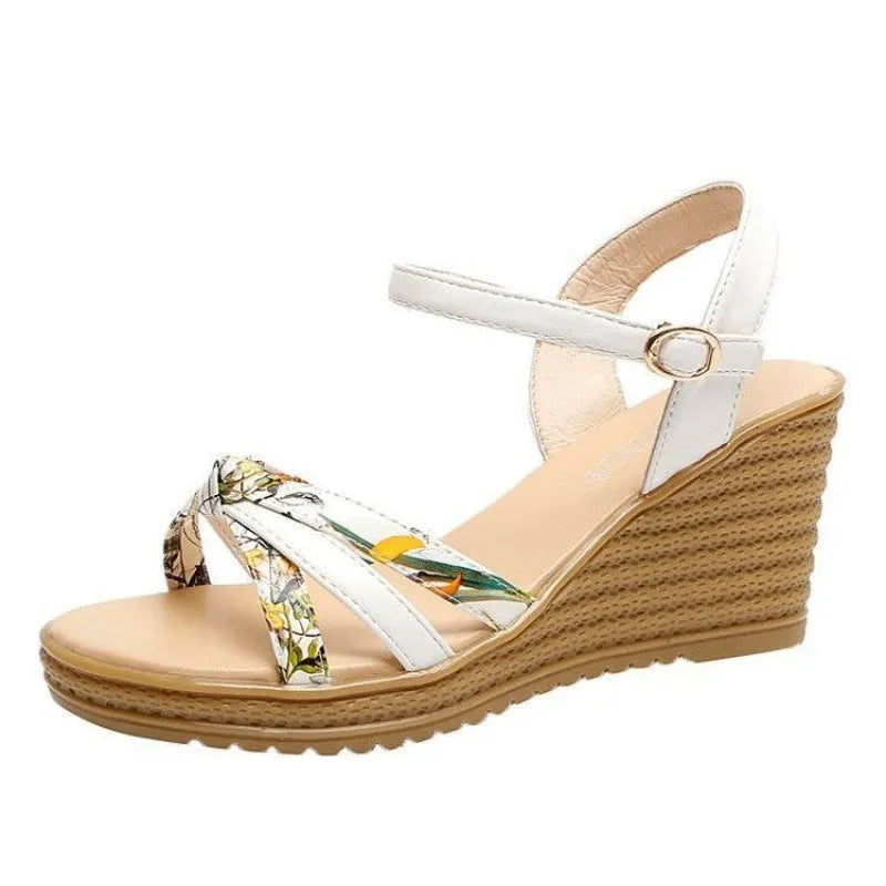 Women's pink wedge heel sandals with a single adjustable buckle strap on a white background.