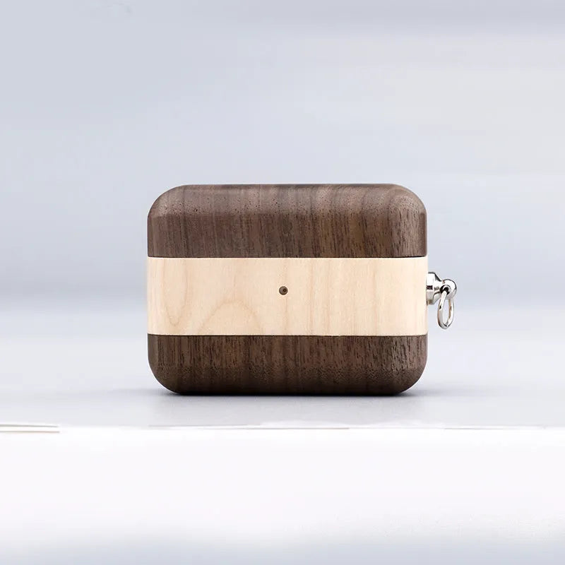 Solid walnut wood protective sleeve for Apple AirPods with attached brown lanyard on a wooden table.