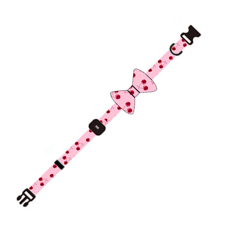 Pink cloth dog leash set with chest strap, collar, and rope on a surface