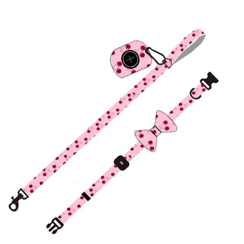 Pink cloth dog leash set with chest strap, collar, and rope on a surface