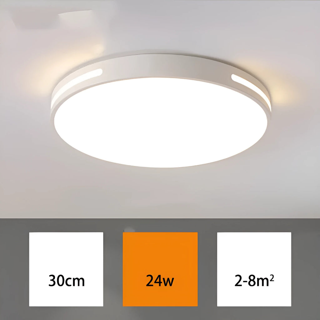 Round modern acrylic ceiling lamp with remote control in white light on a room ceiling.