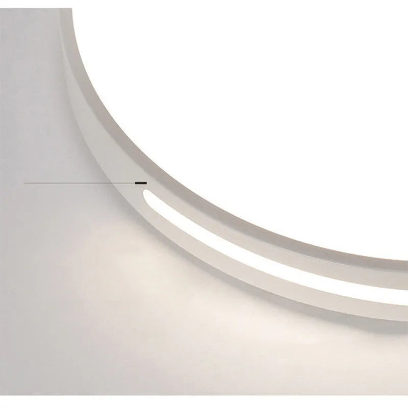 Round modern acrylic ceiling lamp with remote control in white light on a room ceiling.