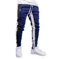 Men's strappy zippered high-waist tight-fit sports trousers in black and white on a model