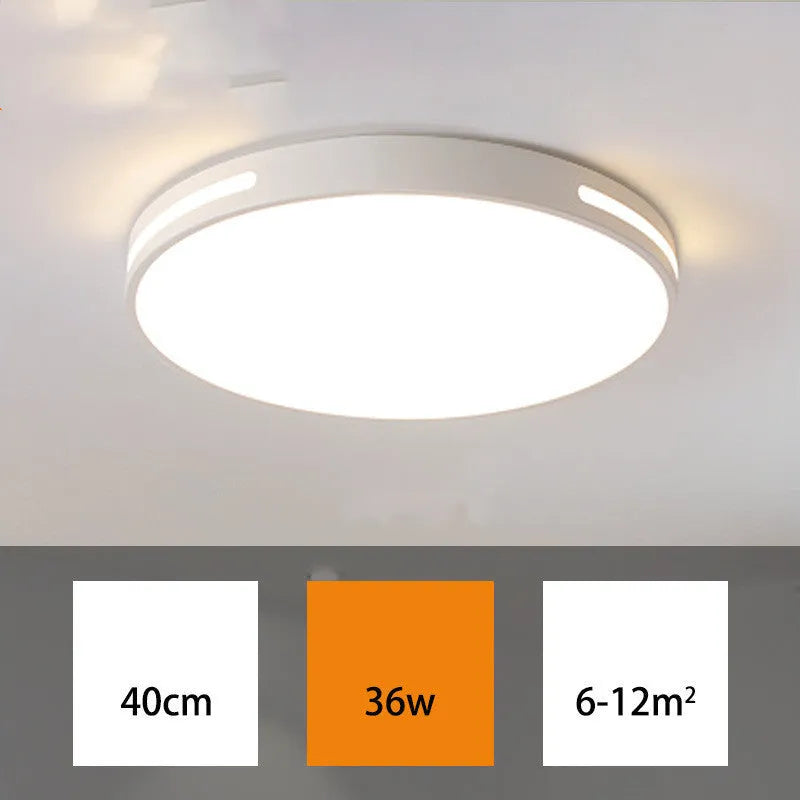 Round modern acrylic ceiling lamp with remote control in white light on a room ceiling.
