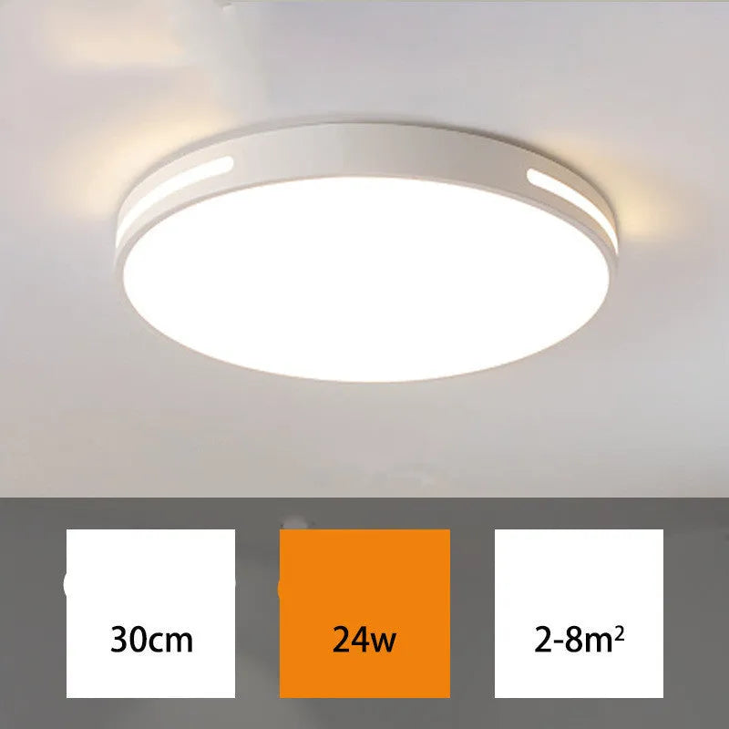 Round modern acrylic ceiling lamp with remote control in white light on a room ceiling.