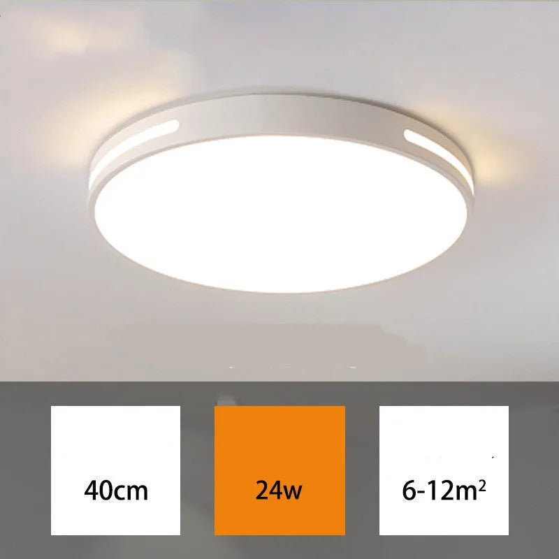 Round modern acrylic ceiling lamp with remote control in white light on a room ceiling.