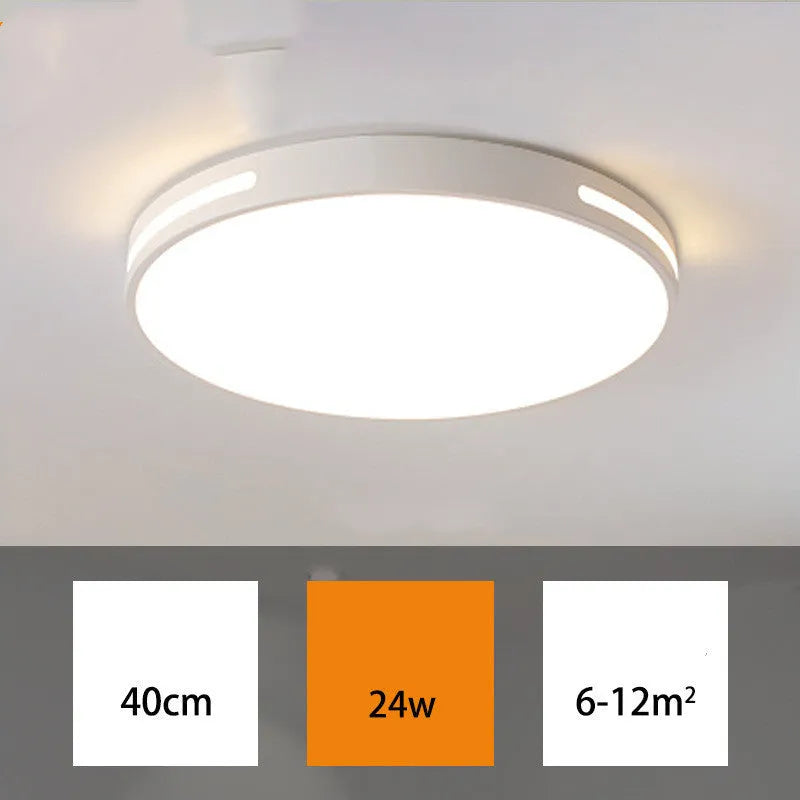 Round modern acrylic ceiling lamp with remote control in white light on a room ceiling.