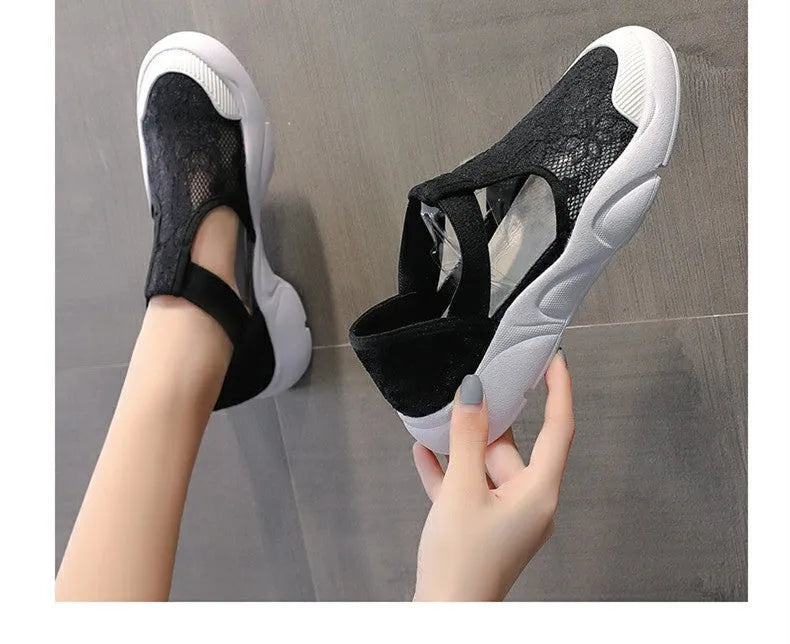 Women's flat fisherman sandal in black with lace and elastic band upper, low heel, and rubber sole