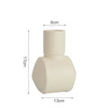 Nordic Morandi style hammer glaze ceramic vase in beige, brown, or purple on a wooden surface.