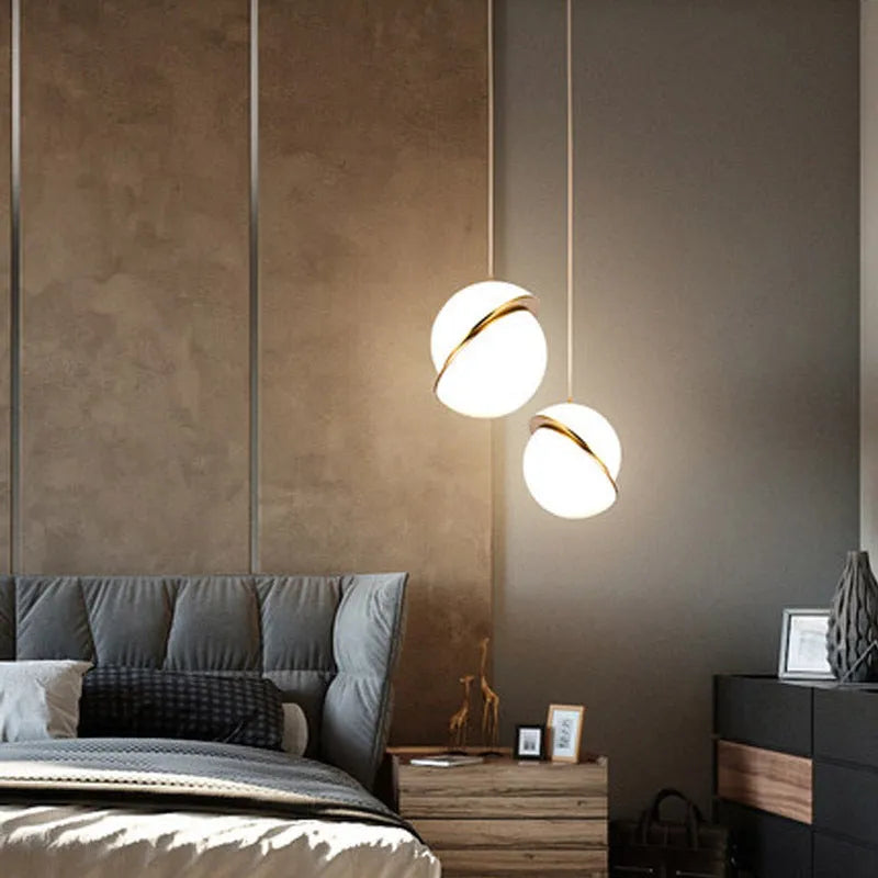 Nordic pendant light with white spherical glass lampshade and golden accents on adjustable cord