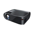 Portable wireless projector with AI voice control on a table, projecting a movie scene onto a wall.